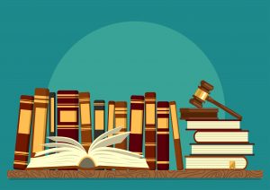 Books on shelf with open book and judge gavel