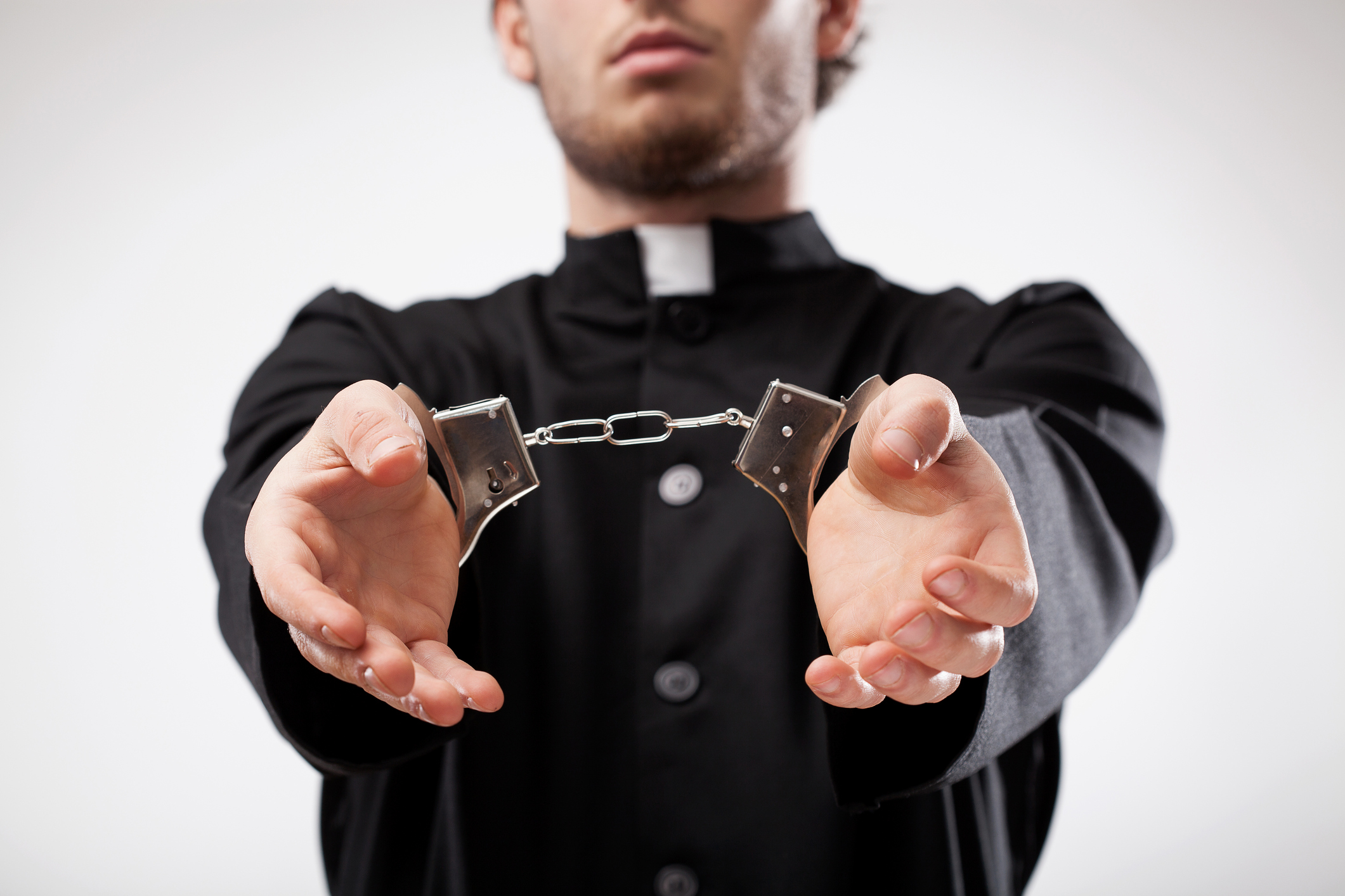priest-in-handcuffs.jpg