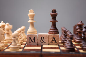 m&a merger King Chess Pieces With Mergers And Acquisitions Text