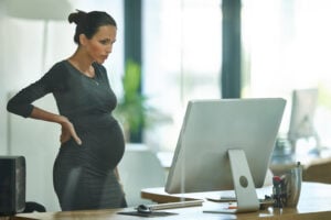 Shot of a pregnant businesswoman working in an office Tying together some loose ends before maternity leave