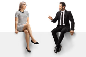 Casual woman and a businessman sitting on a panel and talking