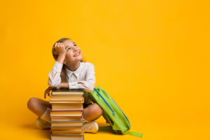 Cute Girl Dreaming About School Sitting With Backpack And Books