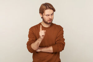 Be careful! Portrait of strict teacher, bossy man with beard wearing sweatshirt standing with admonishing gesture