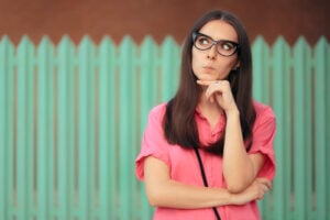 Funny Girl with Cat-eye Glasses Thinking Making Plans