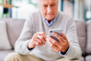 texting Shot of a senior man using a phone at a clinic