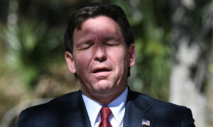 Florida Gov. Ron DeSantis reacts when asked whether he would
