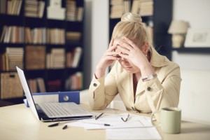 Unhappy young woman tax lawyer paying bills