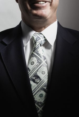 Businessman wearing tie made from cash, close-up