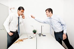 businessman throwing coffee to his colleague