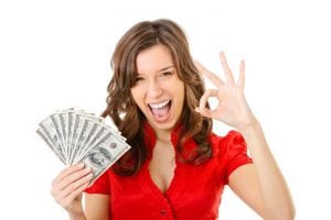 Happy young woman showing money