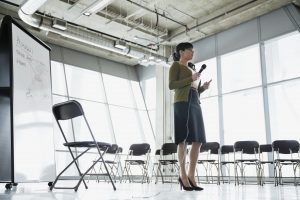 Businesswoman practicing presentation in office building