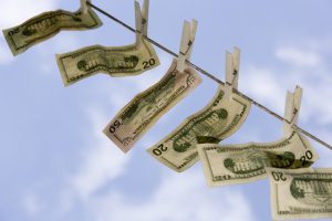 Dollar bills hanging from clothesline