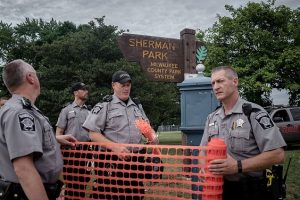 Law enforcement fence-off Sherman Park in Milwaukee, Wisconsin August 15, 2016, after police in the Midwestern city faced off with protesters August 13 and 14 following the death of 23-year-old Sylville Smith, who officials say was armed.   / AFP / Cengiz Yar       