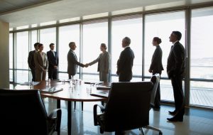 merger meeting conference room handshake shaking hands