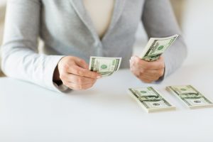woman counting bonus money