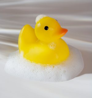 Close up of rubber duck toy with soap bubbles