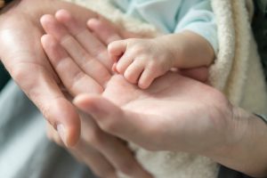 baby with parents hands