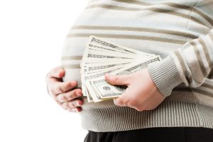 pregnant woman with cash money paid surrogate surrogacy