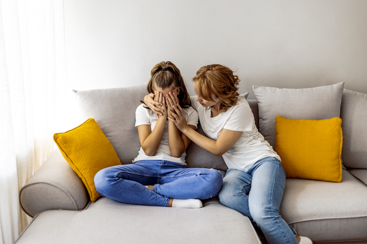 Affectionate mature mommy supporting stressed teen daughter