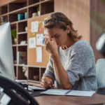 Business woman having headache at office