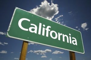 Green California Road Sign with Dramatic Clouds and Sky.