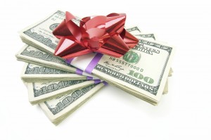 Stack of Money with Bow Isolated on a White Background.
