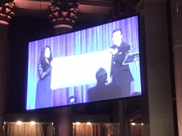 Don H. Liu and Nora Boujida with a giant $15,000 check.