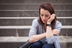 sad unhappy young woman law student