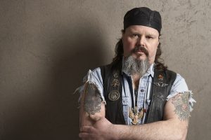 Male biker with tattoos on arms, portrait