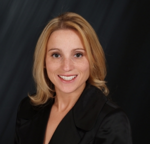 Kerri Strug (Not pictured: Béla Károlyi holding her up to the camera)