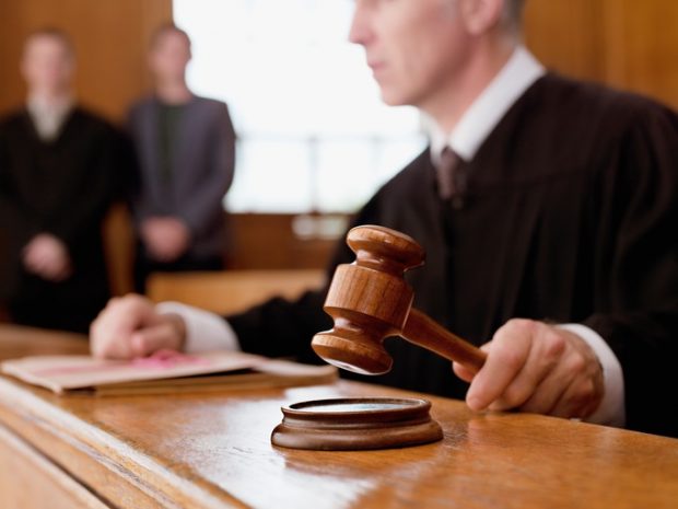 judge with gavel in courtroom court