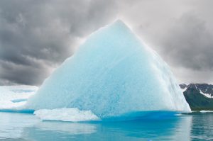 Triangular iceberg on gloomy day, Bear Lake, Kenai Fjords National Park, Alaska.