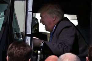 Trump plays with a truck like I would have... when I was seven. (Generated by IJG JPEG Library)