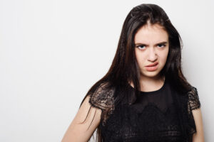 ugh you can’t sit with us Closeup portrait young woman with bad attitude, looking at you isolated grey background.