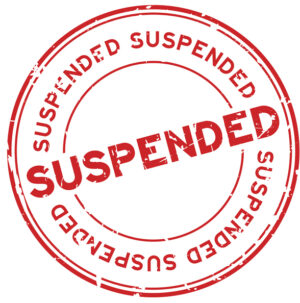 Grunge red suspended round rubber seal stamp on white background