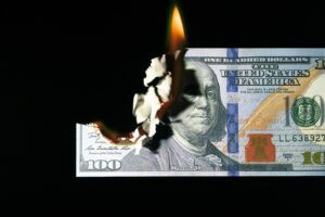 Close up shot of a 100 dollar banknote burning