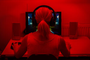 rear view of a young woman playing computer games