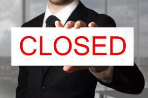 businessman holding sign closed lawyer law firm
