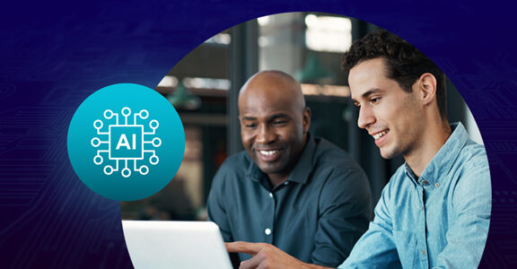 Two men viewing a laptop screen.