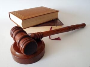 Close-up of a judge’s gavel near a law book, symbolizing legal expertise, court proceedings, litigation, legal research, and the practice of law for attorneys, law firms, and legal professionals.